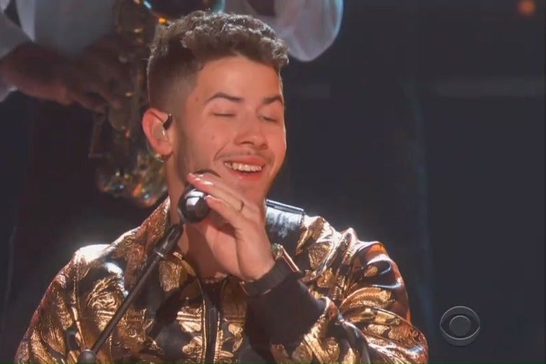 In a close-up of Nick Jonas singing into a microphone at the Grammys, some food is visible between his teeth.
