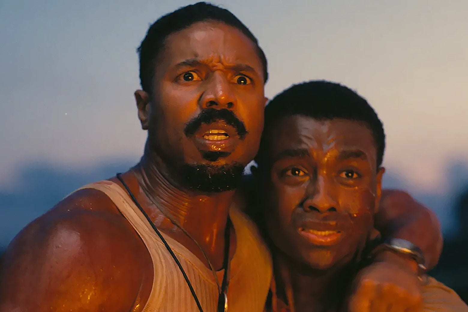 Two men looking terrified as they stare bewilderingly ahead.