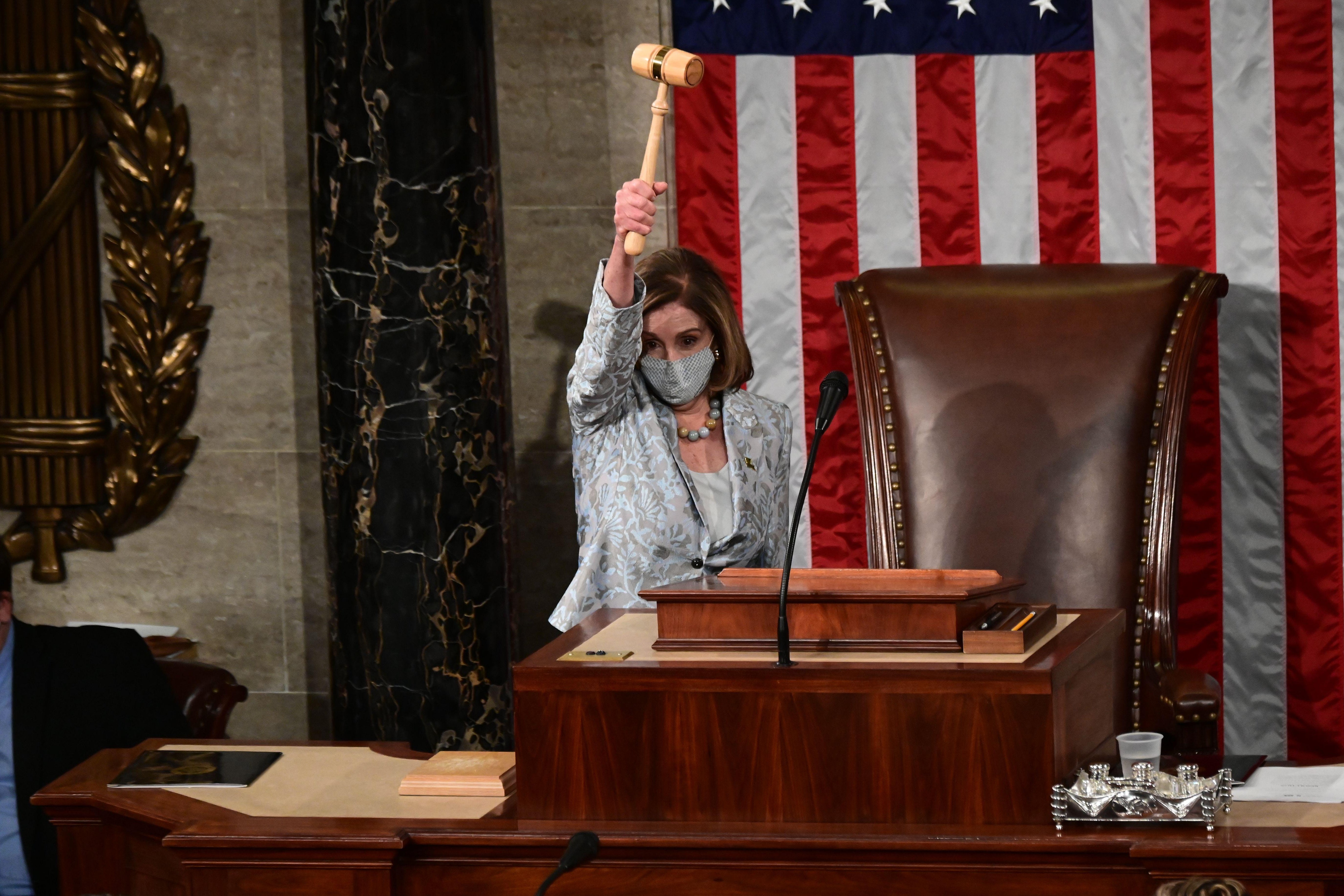 Speaker of the House Nancy Pelosi wields the Speaker's gavel after being re-elected as Speaker and preparing to swear in members of the 117th House of Representatives in Washington, D.C. on January 3, 2021. 
