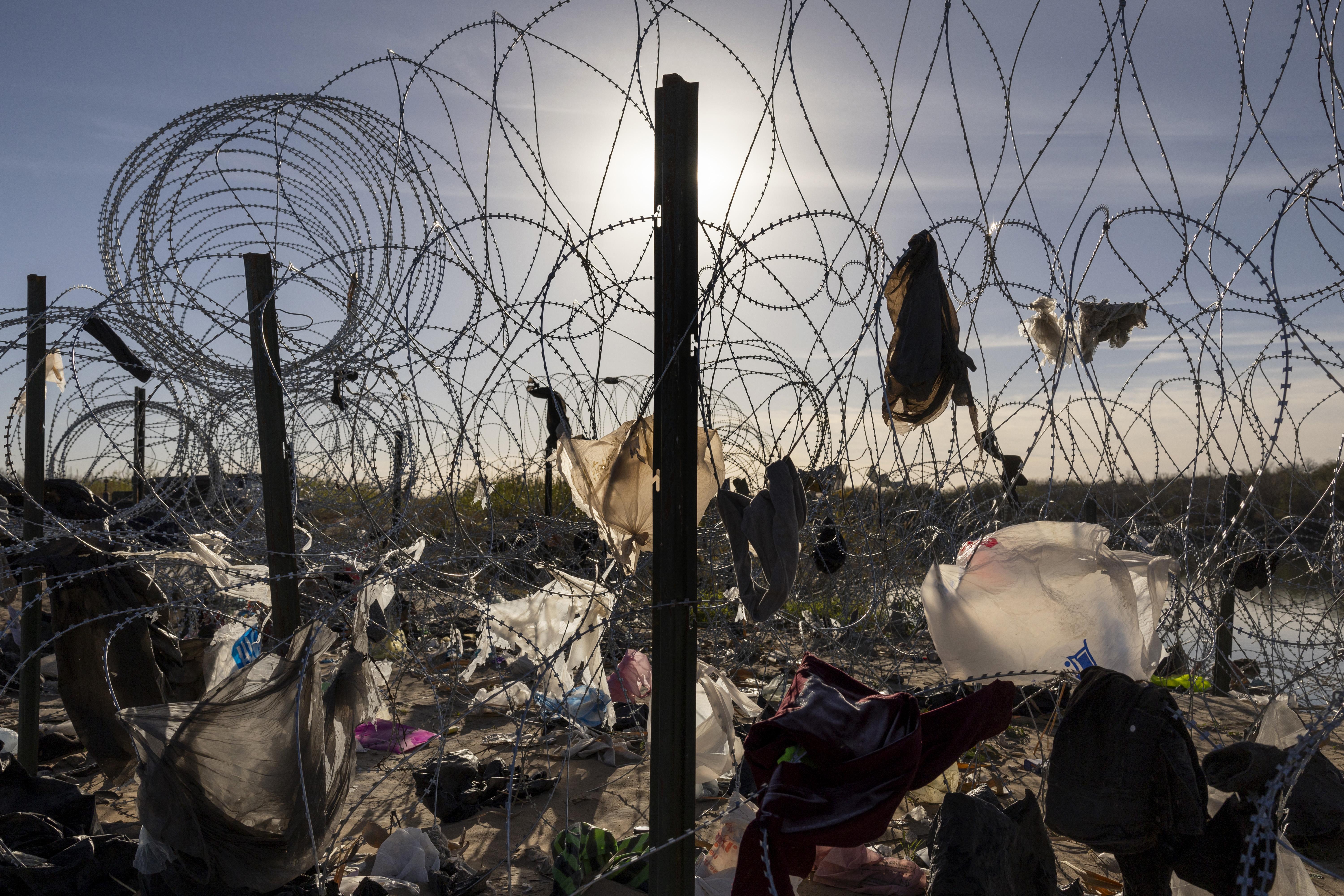 Clothing and plastic bags hang caught in razor wire near the Rio Grande on January 10, 2024 in Eagle Pass, Texas.