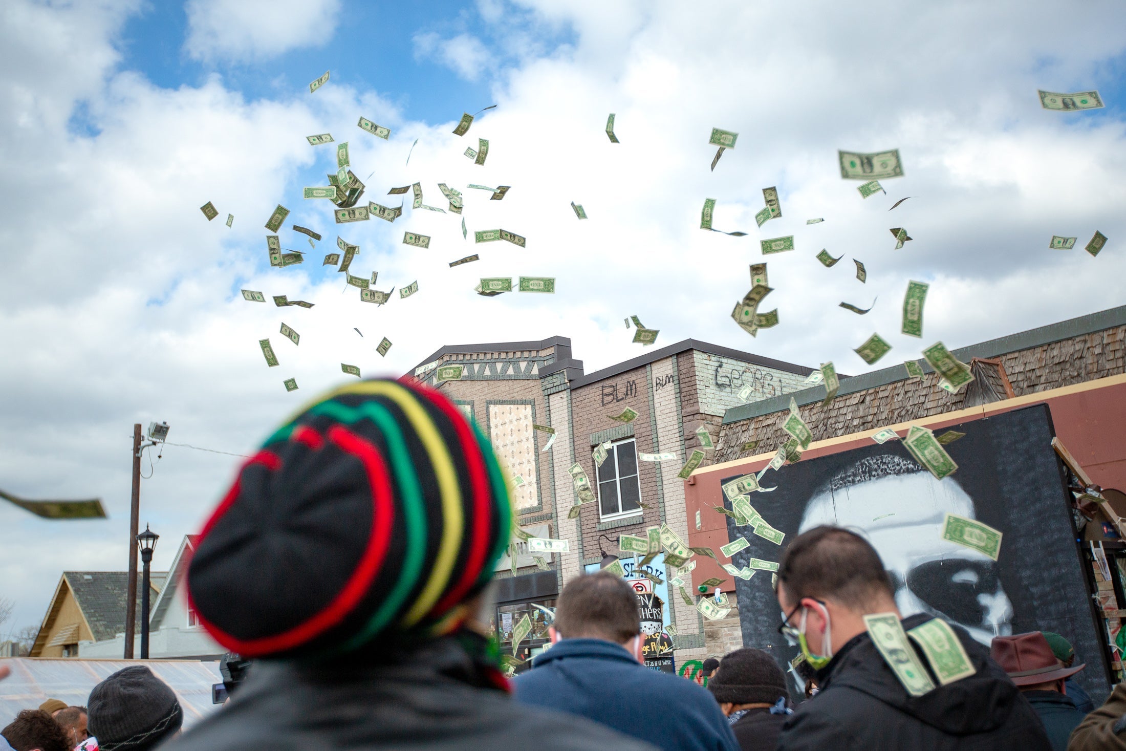 Cash flies in the air above George Floyd Square. 