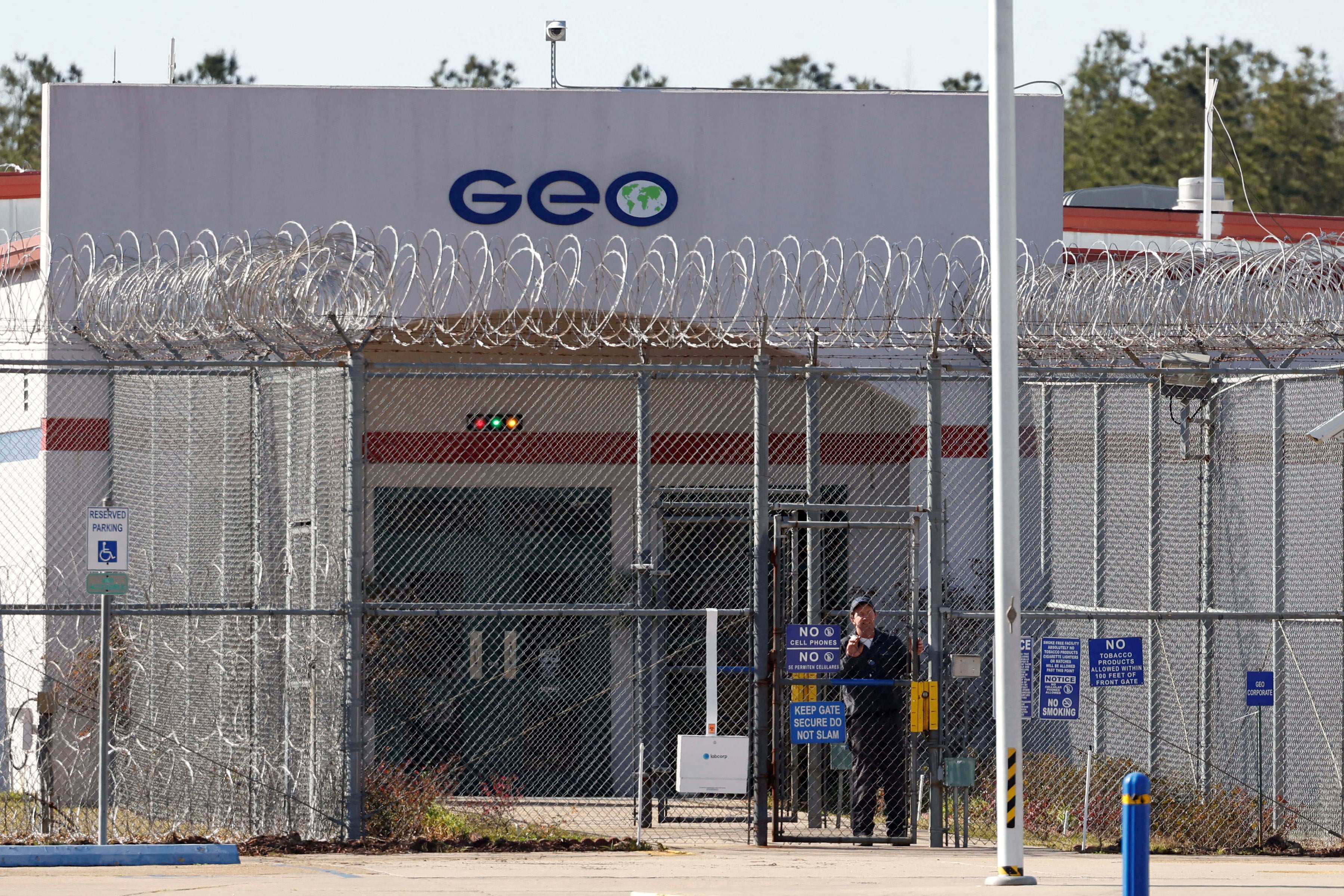 A facility featuring a GEO logo and surrounded by barbed-wire fencing.