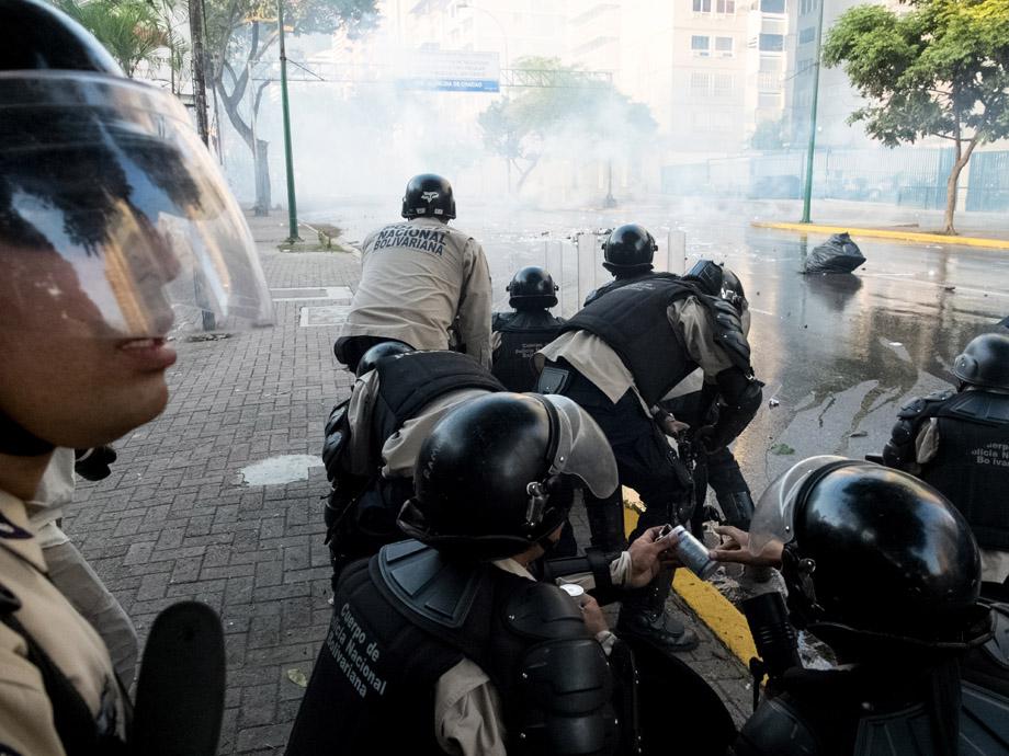 Members of the National Bolivarian Guard fire tear gas to disperse protesters during an anti-government demonstration in the Altamira neighborhood of Caracas, Venezuela, on February 19, 2014.