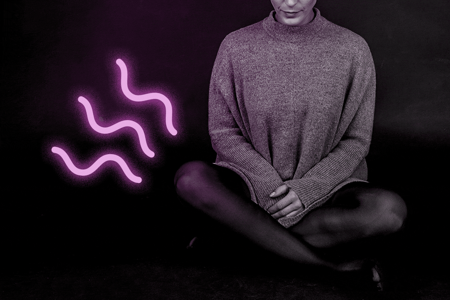 Woman sitting cross-legged next to a neon illustration of odor or smell