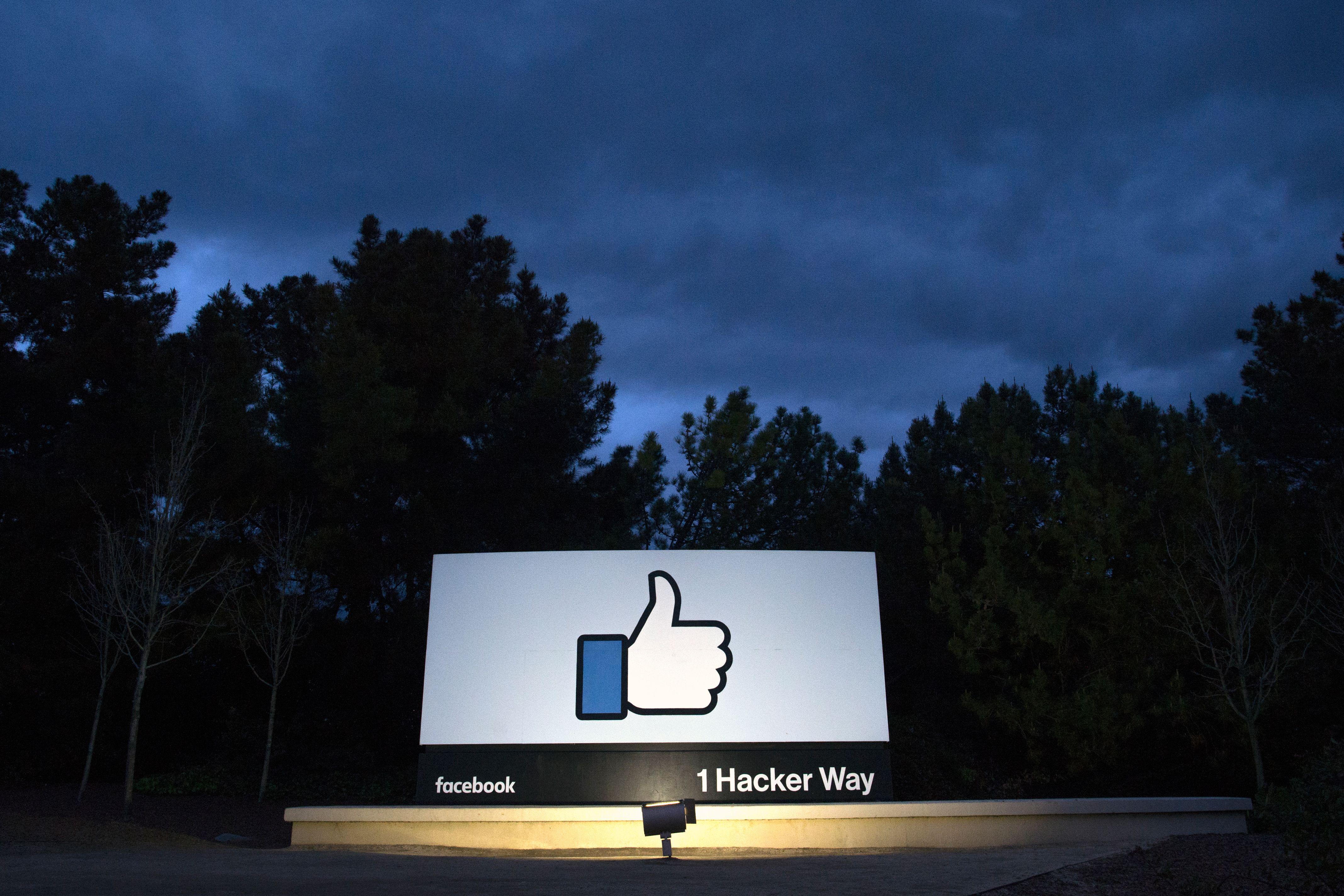 TOPSHOT - A lit sign is seen at the entrance to Facebook's corporate headquarters location in Menlo Park, California on March 21, 2018. 
Facebook chief Mark Zuckerberg vowed on March 21 to 'step up' to fix problems at the social media giant, as it fights a snowballing scandal over the hijacking of personal data from millions of its users. / AFP PHOTO / JOSH EDELSON        (Photo credit should read JOSH EDELSON/AFP/Getty Images)
