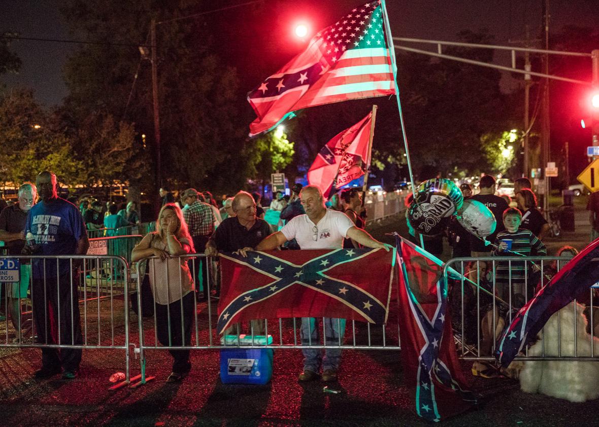 Protestors hold flags across the street from the G.T. Beauregard Monument before its removal on May 16, 2017 in New Orleans, Louisiana. 