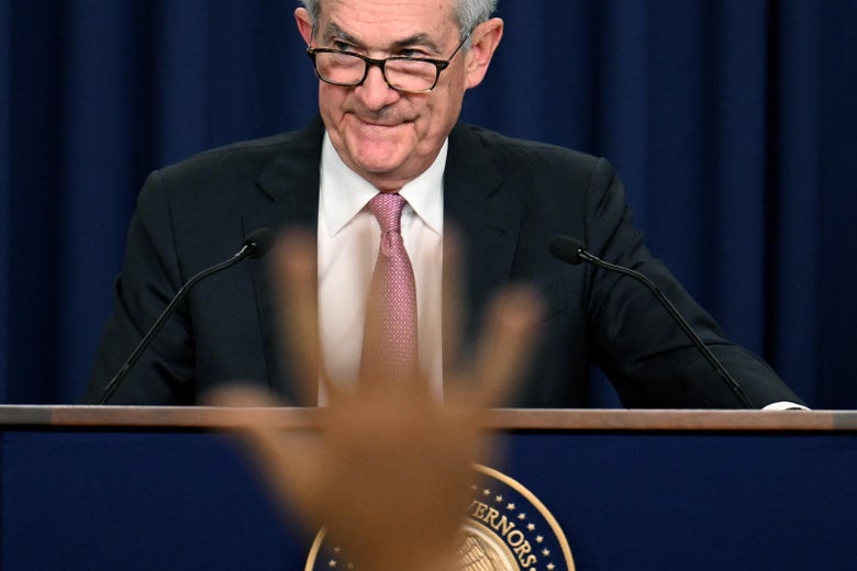 Jerome Powell standing at a podium during a news conference in Washington