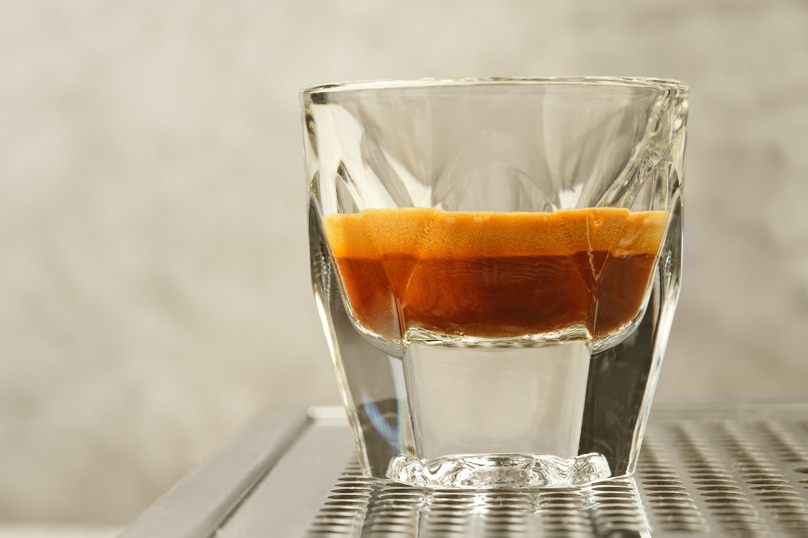 A glass shotglass with espresso.