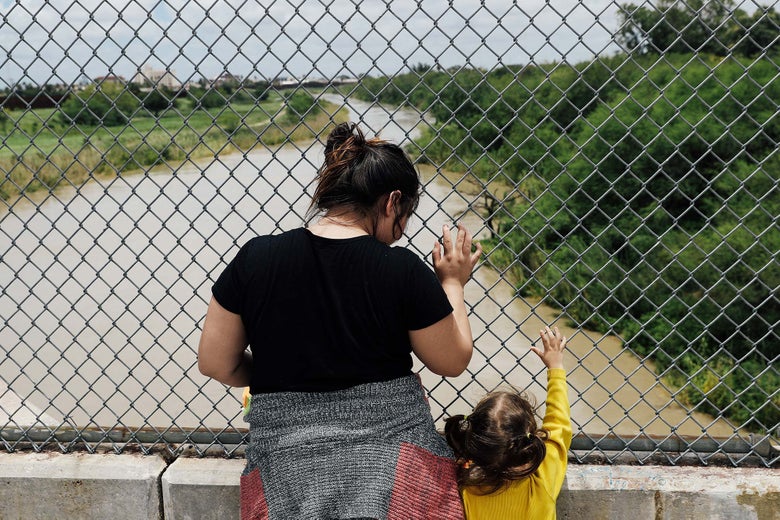 A Honduran mother and her 3-year-old daughter seeking asylum wait on the Mexican side of a border checkpoint near Brownsville, Texas, on Monday.