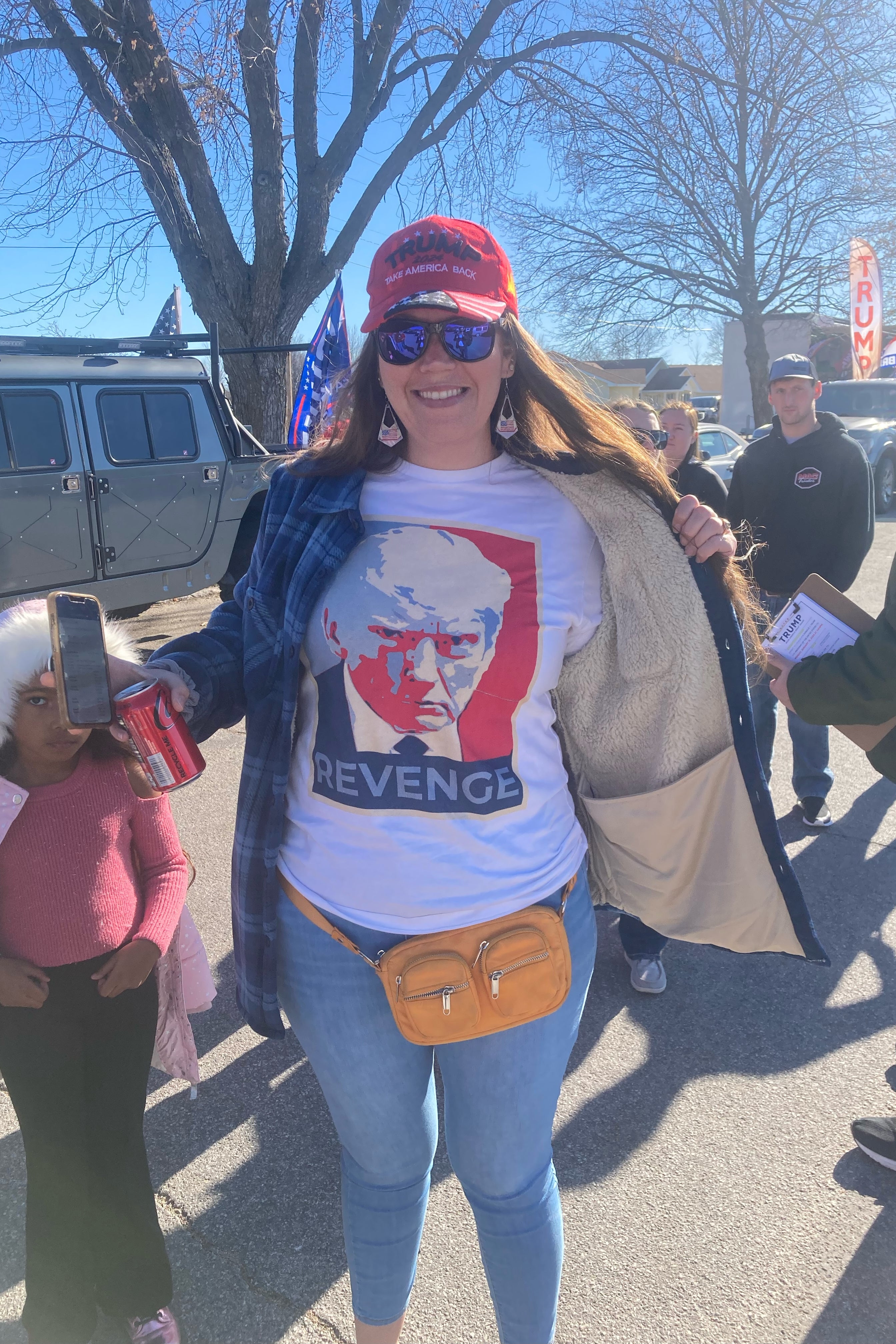 A woman wears a T-shirt that says, "Revenge" and features a photo of Trump in the style of Shepard Fairey's Obama "Hope" poster.