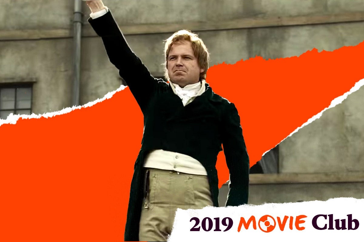 Rory Kinnear raises his fist while wearing period clothes in Peterloo. Text in the corner says, "2019 Movie Club."