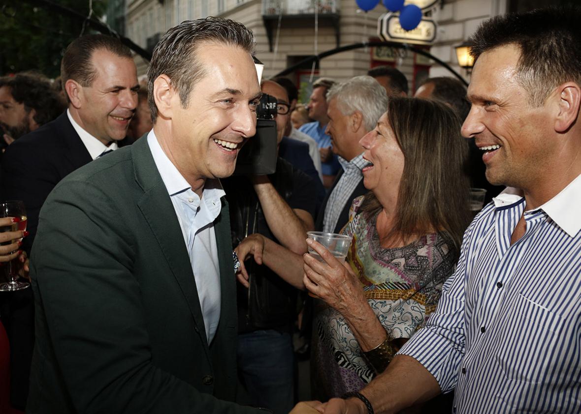 Heinz-Christian Strache (left), leader of the right-wing Austrian Freedom Party, celebrates with supporters after European Parliament elections on May 25, 2014, in Vienna.
