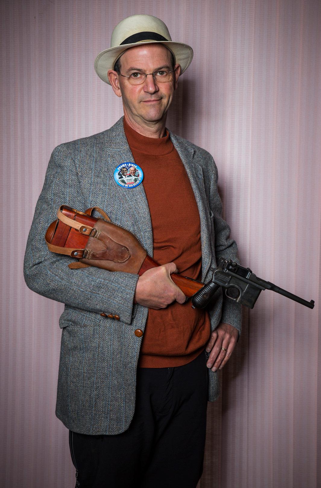 Writer Dan Baum holds his beloved 7.63-mm Mauser C96, made in 1896, at his home on Feb. 24, 2013, in Boulder, Colo.
