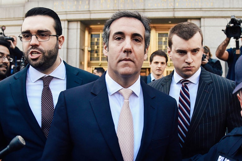 Michael Cohen leaves the U.S. Courthouse in New York, surrounded by police, his lawyers, and journalists.