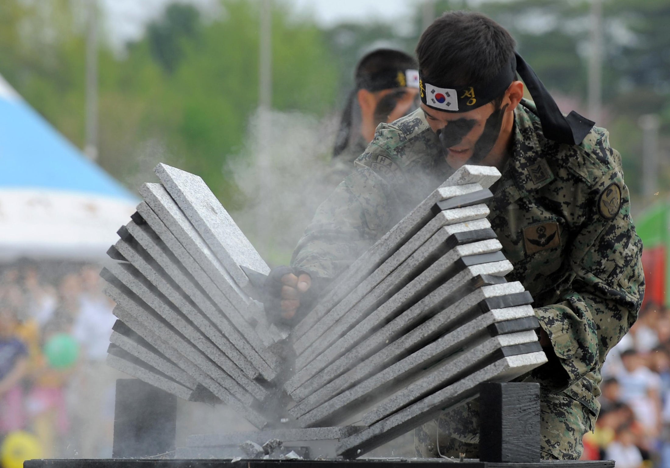 How do martial artists break concrete blocks?