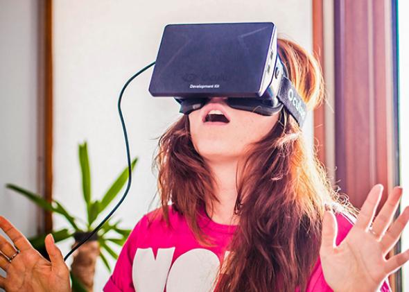 A young woman uses the Oculus Rift.