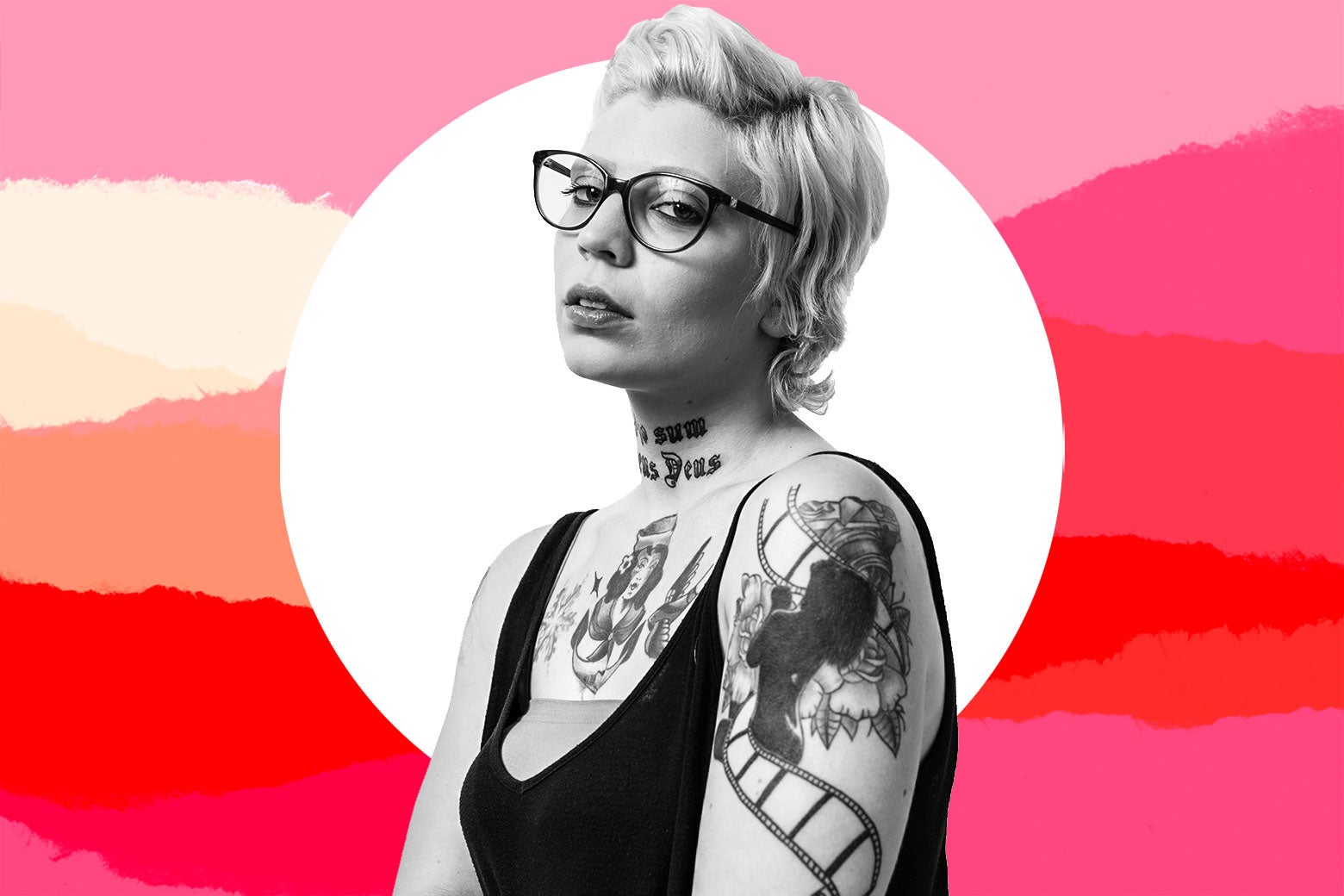 A woman with tattoos and glasses looks lonely.