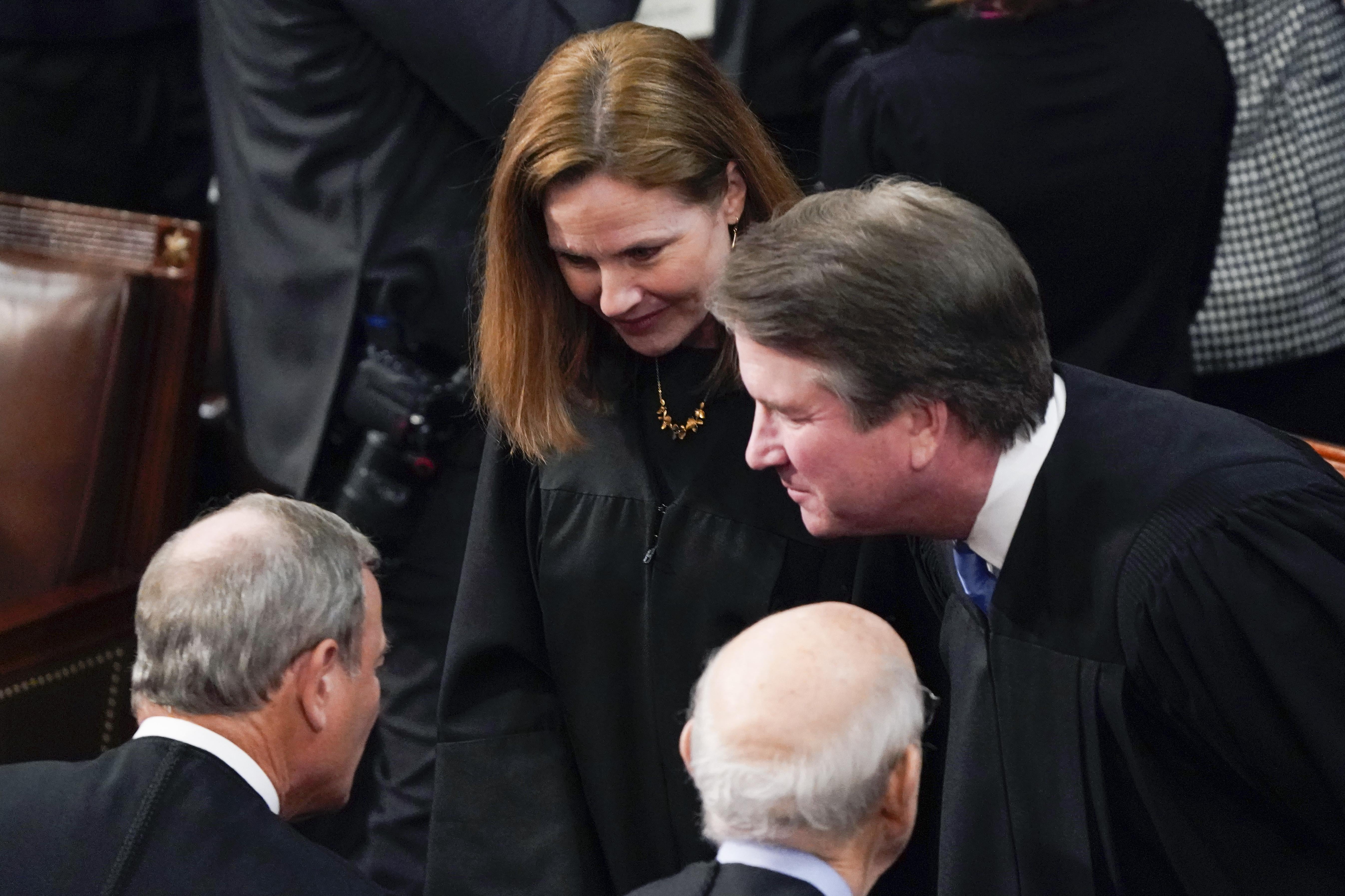Barrett and Kavanaugh lean in toward Roberts and Breyer, all wearing their robes