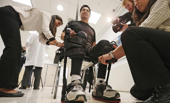  Robert Woo is outfitted with an exoskeleton device to walk in made by Ekso Bionics.