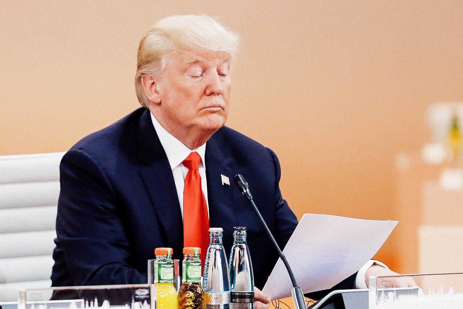 President Donald Trump reads a document on the second day of the G20 economic summit on July 8, 2017 in Hamburg, Germany.