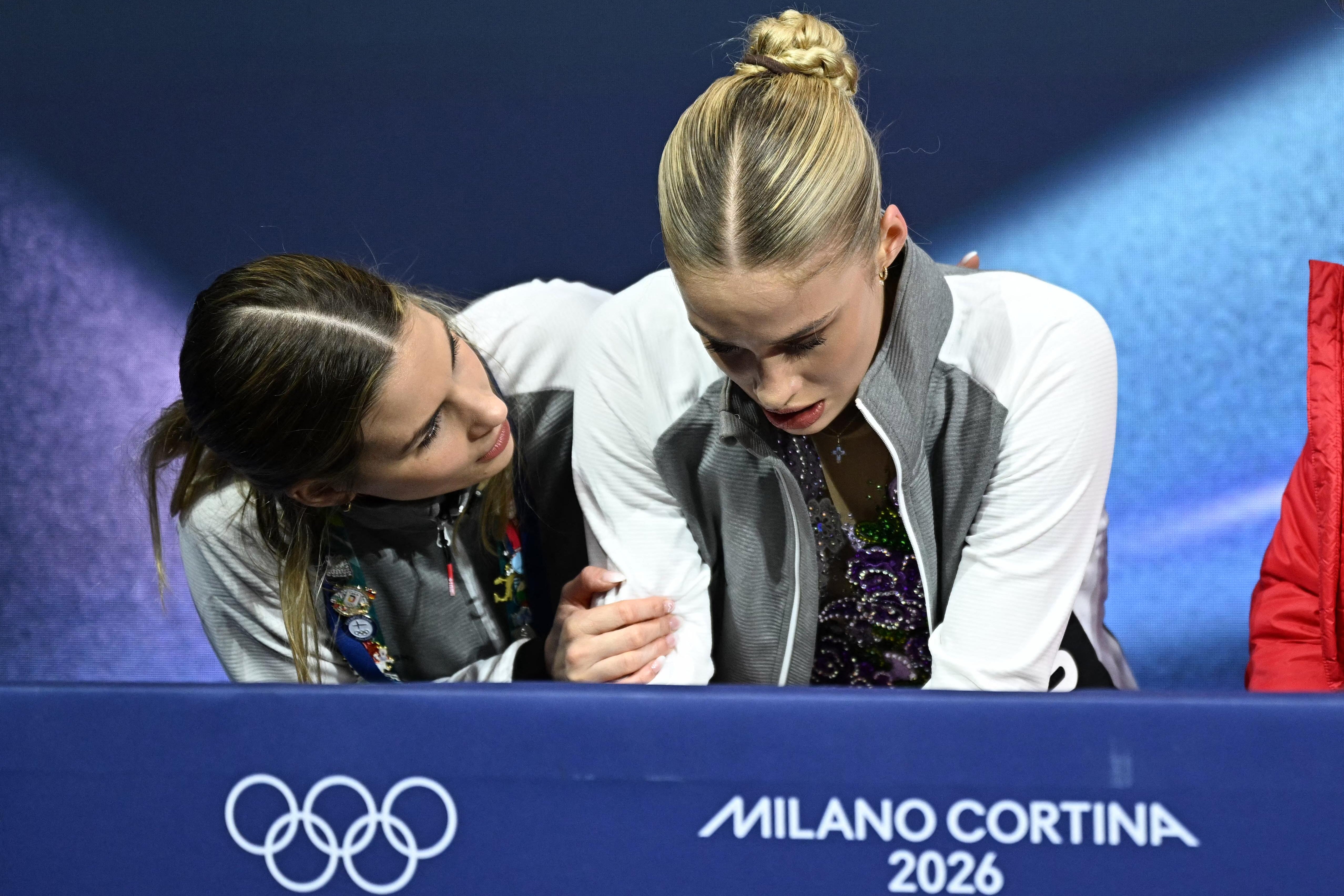 Switzerland's Kimmy Repond (R) reacts in the kiss and cry area after competing in the figure skating women's single free skating final during the Milano Cortina 2026 Winter Olympic Games at Milano Ice Skating Arena in Milan on February 19, 2026. (Photo by Gabriel BOUYS / AFP via Getty Images)
