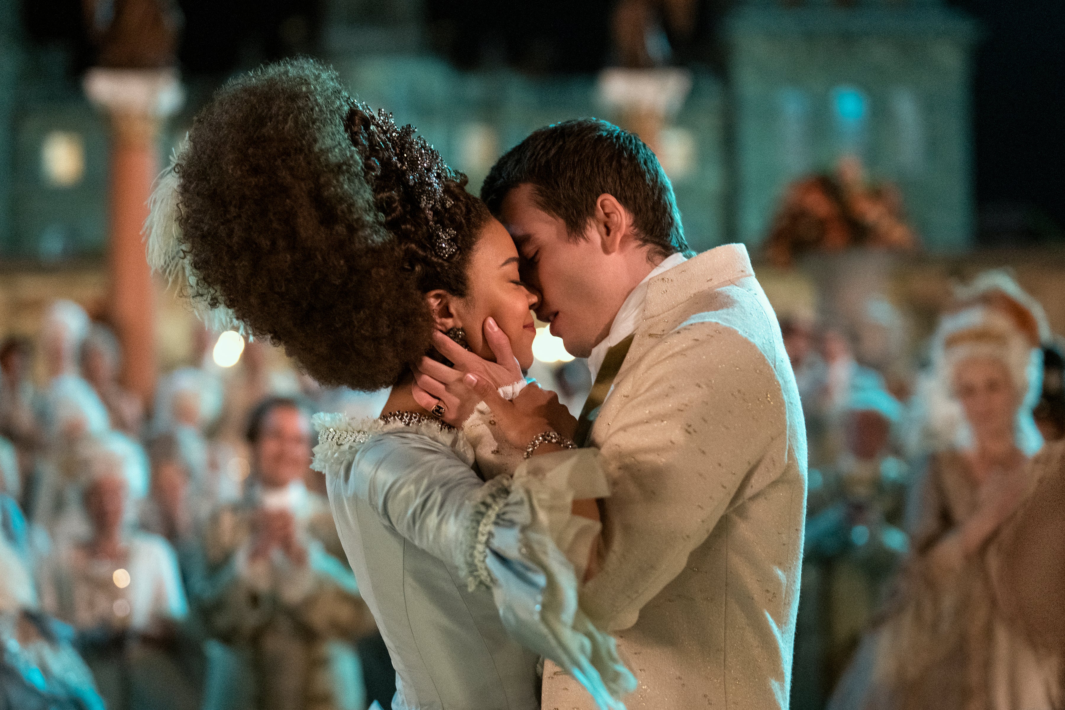 George and Charlotte kiss at a party. Charlotte has very high Marie Antoinette-style hair.