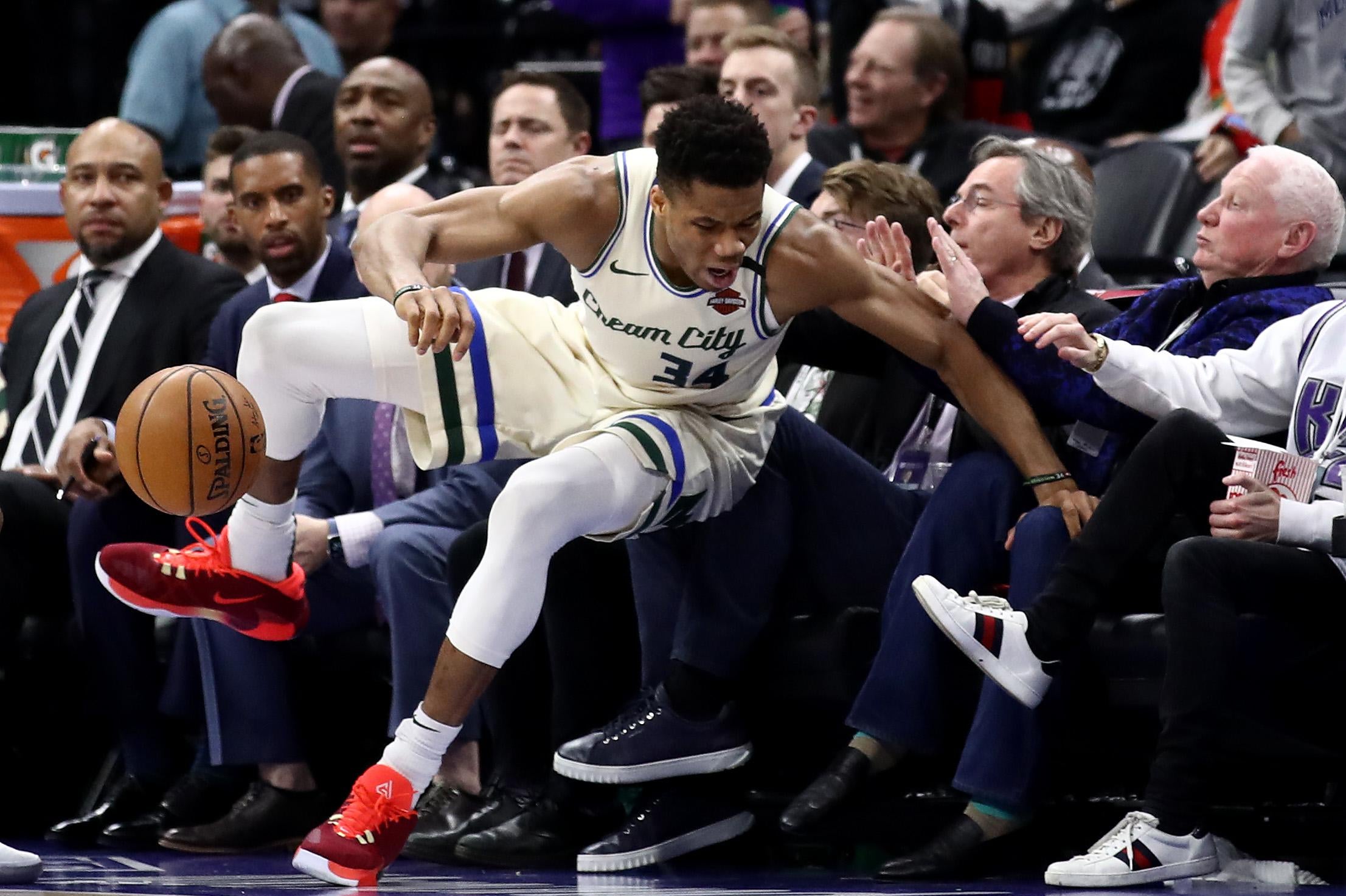 Giannis Antetokounmpo falls into the crowd during a game in January in Sacramento.