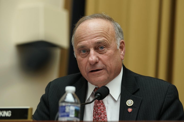 Steve King sits behind a desk with a microphone and bottle of water.