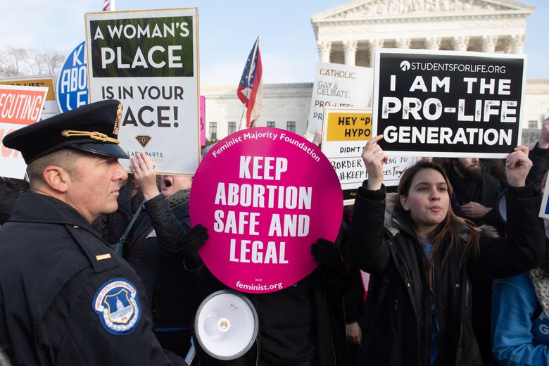 Pro-choice activists hold signs in response to the anti-abortion March for Life outside the U.S. Supreme Court in Washington, D.C., on January 18, 2019.