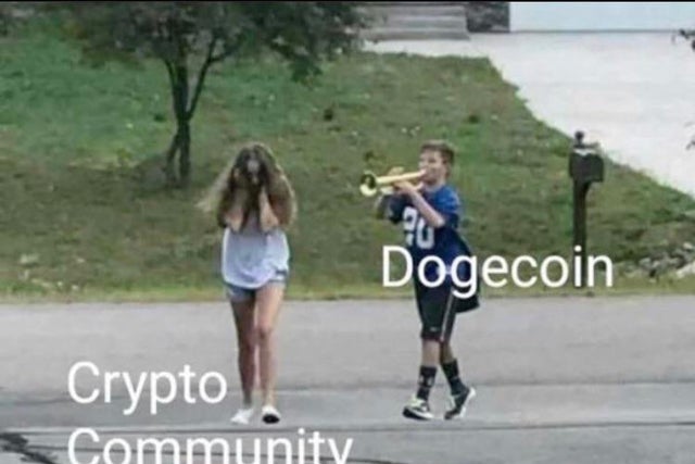 Meme of a boy labeled "Dogecoin" blasting his trumpet at a girl labeled "Crypto Community" covering her ears