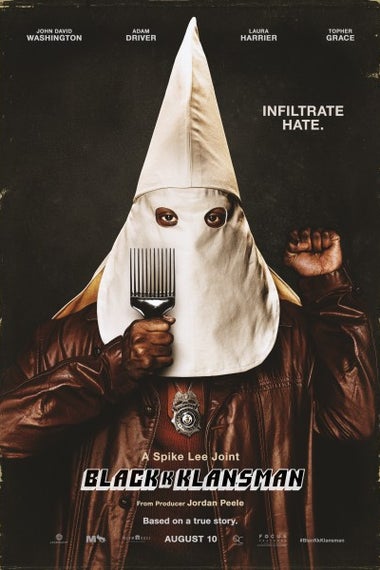 A poster for BlacKkKlansman: John David Washington, who is black, stands with a white hood over his head and a police badge around his neck. His hand is raised in a fist.