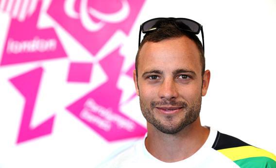 Oscar Pistorius of South Africa smiles in a press conference
