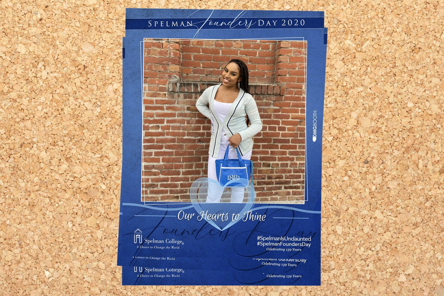 Olivia in Spelman gear, posing in front of a brick wall.