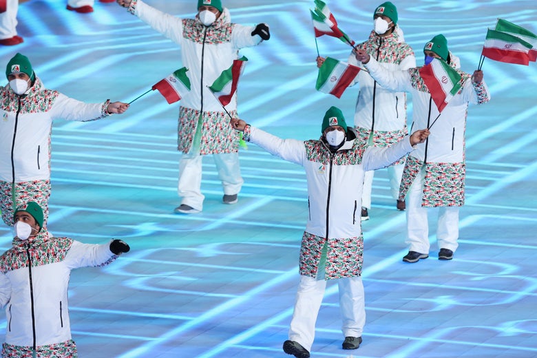 Team Iran walks with flags as a group.
