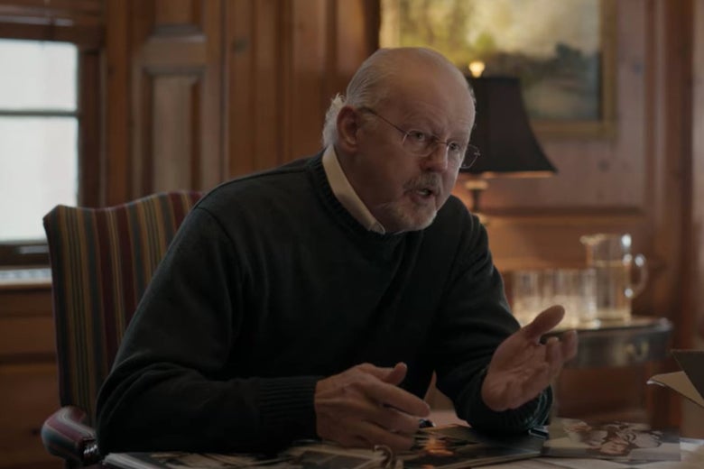 The dean of Pembroke sits at a desk.