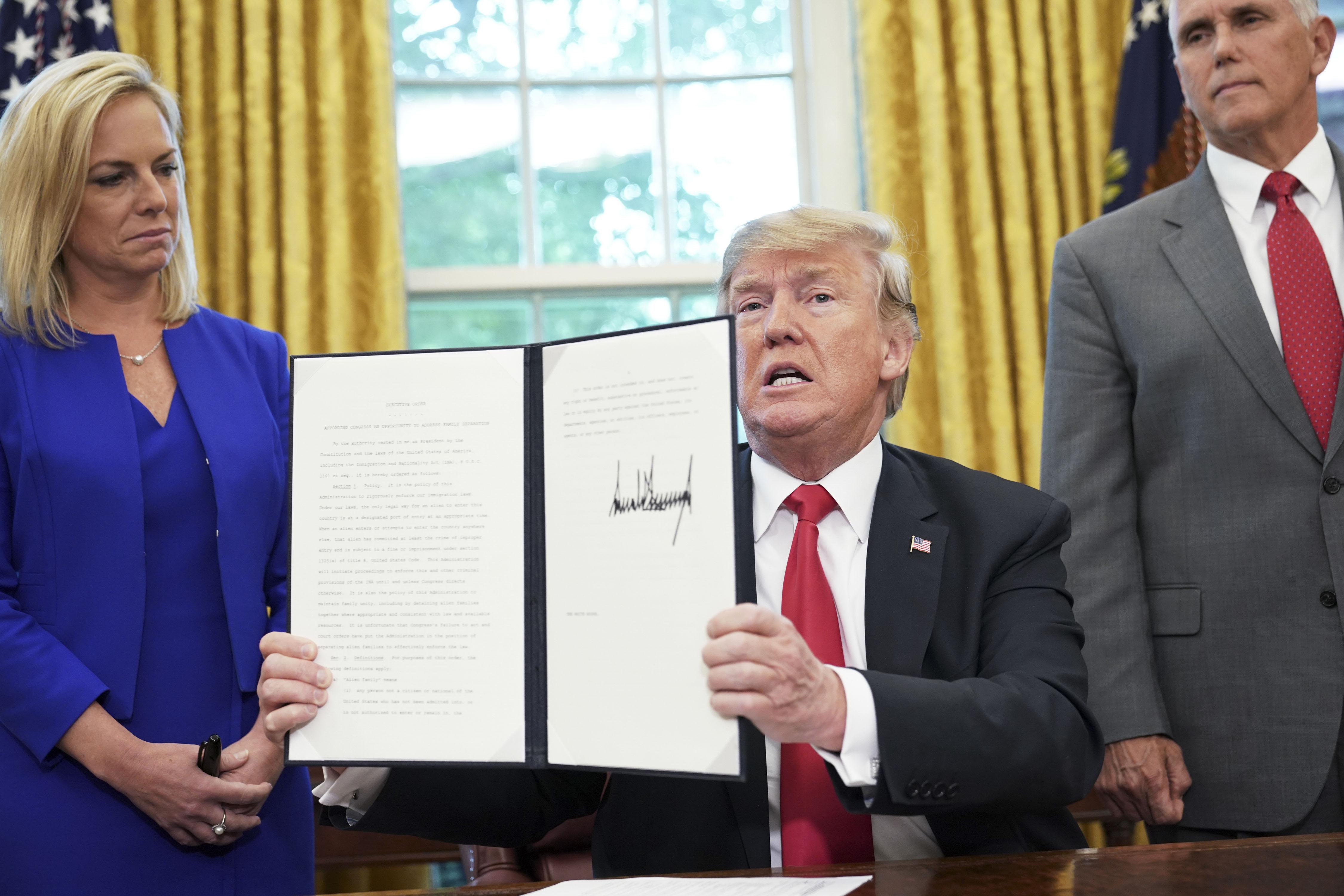 Kirstjen Nielsen, Vice President Mike Pence, President Donald Trump with the immigration executive order.