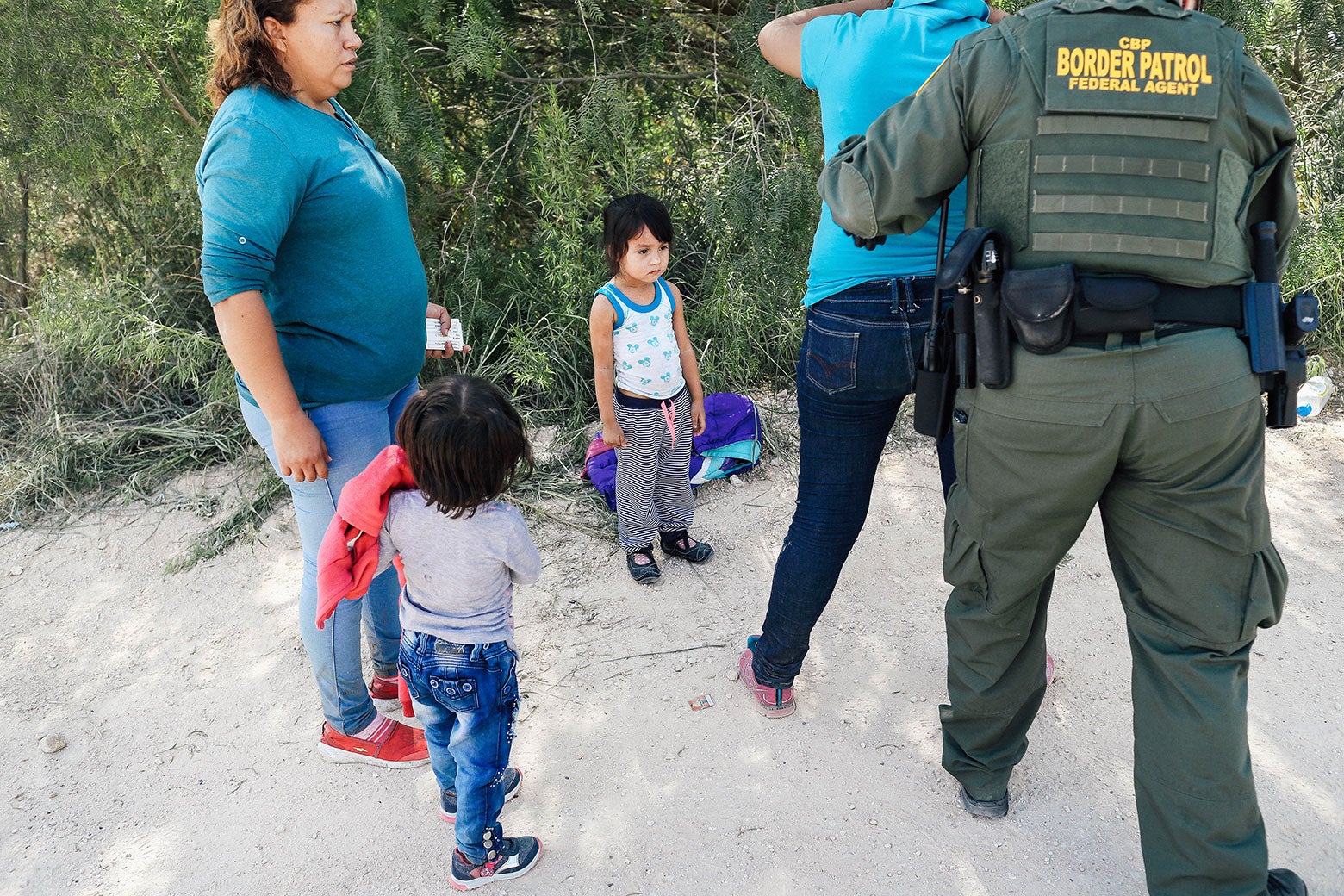 Little kids watch as Border Patrol agents take asylum seekers into custody