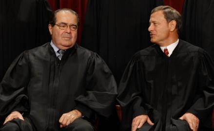 U.S. Supreme Court Associate Justice Antonin Scalia (L) and Chief Justice John Roberts talk while posing for photographs in the East Conference Room at the Supreme Court building October 8, 2010 in Washington, DC. 