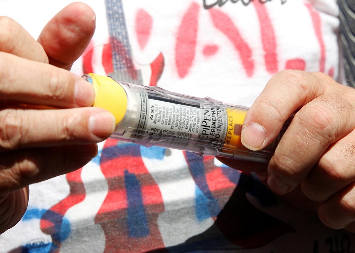 Lunceford Stevens holds an EpiPen during a protest outside the offices of hedge fund manager John Paulson over his fund's investment in Mylan, which manufactures EpiPens, in New York City, U.S., August 30, 2016. 