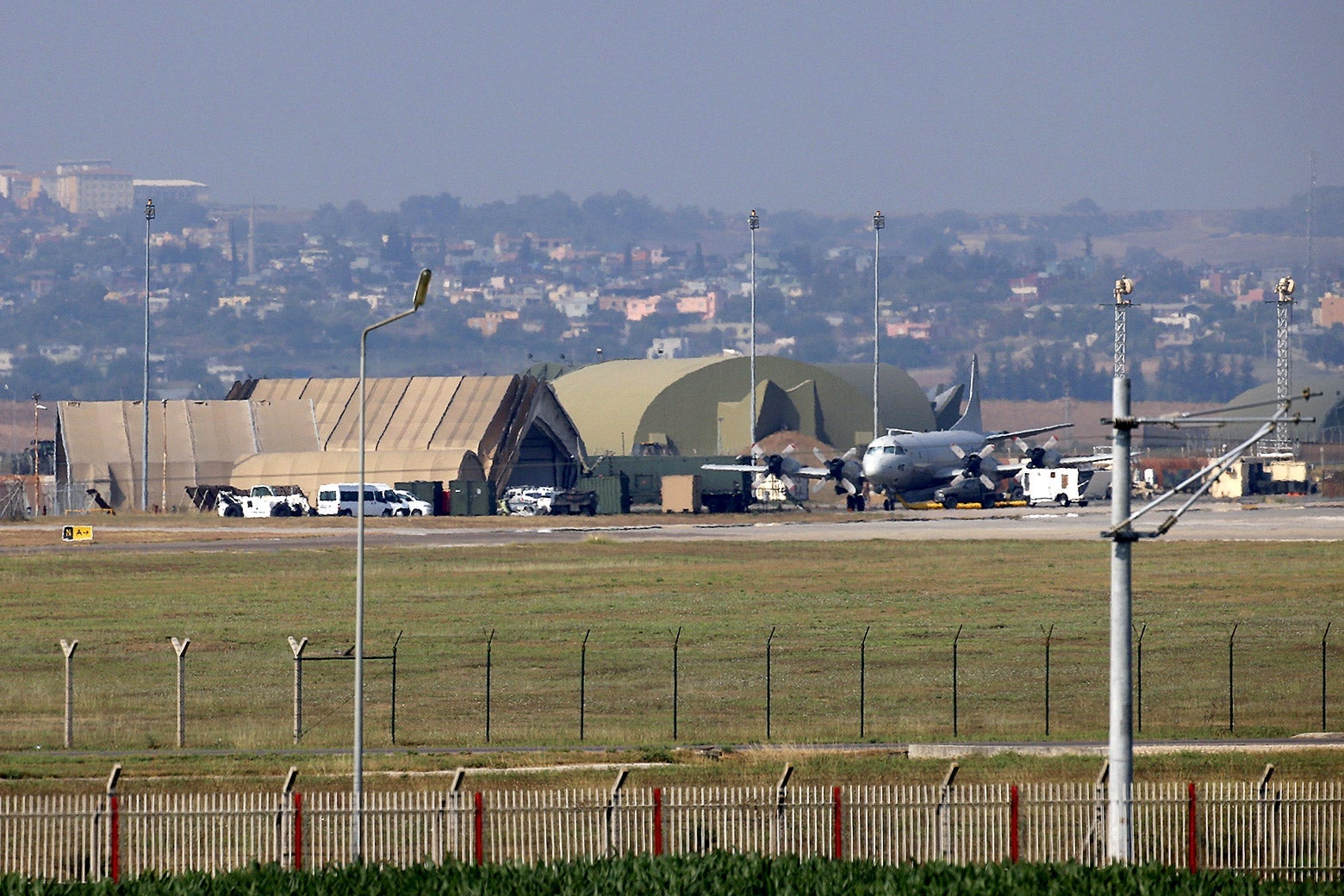A plane sits near a hangar at an air base in Turkey.