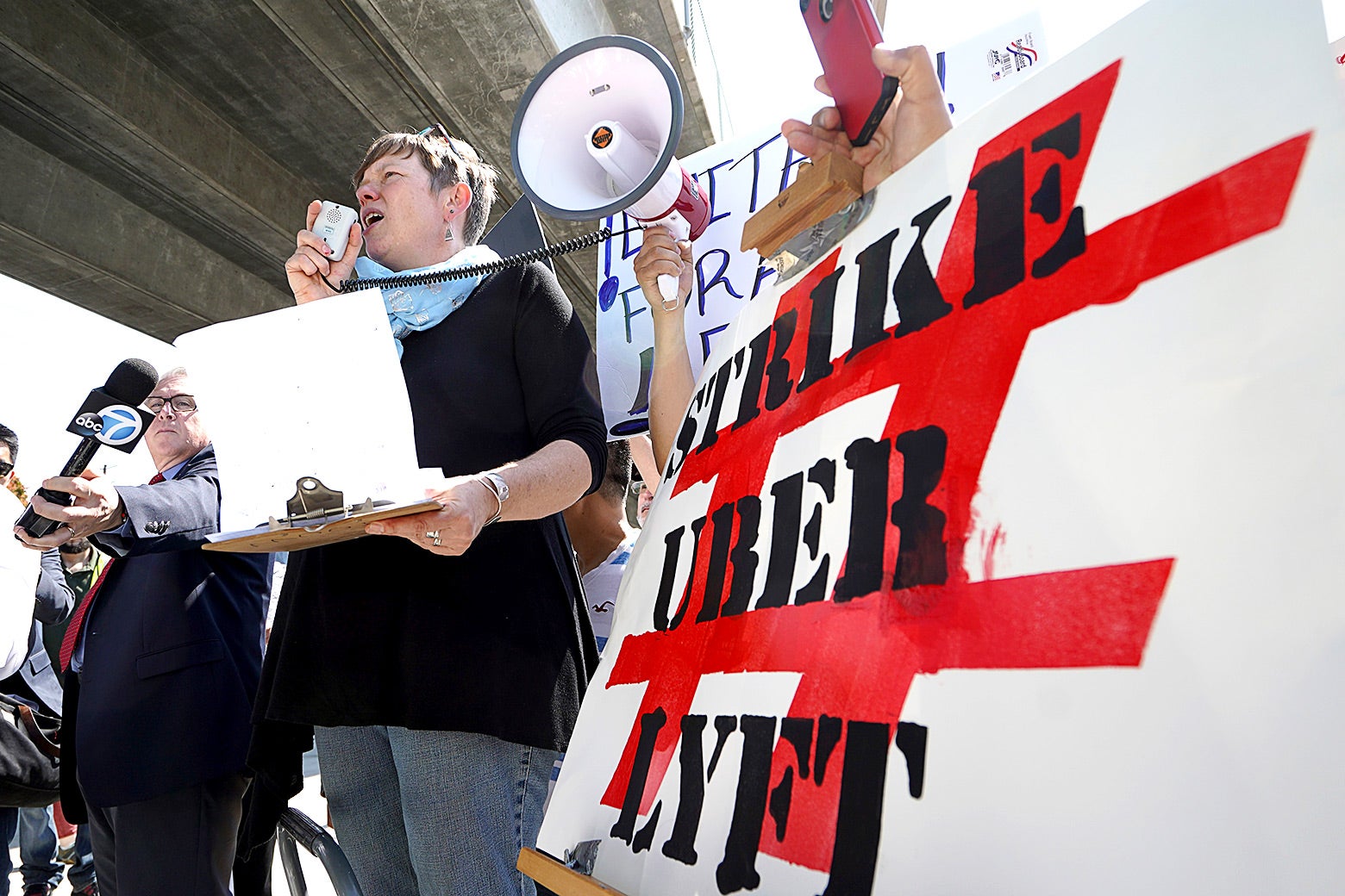 Driver and strike organizer Nicole Moore speaks during a one-day strike against Uber and Lyft in front of an Uber office.