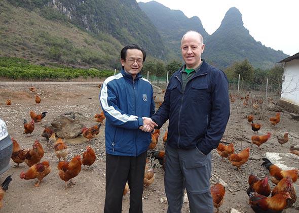Daszak, right, at a free range poultry farm in China.	,					