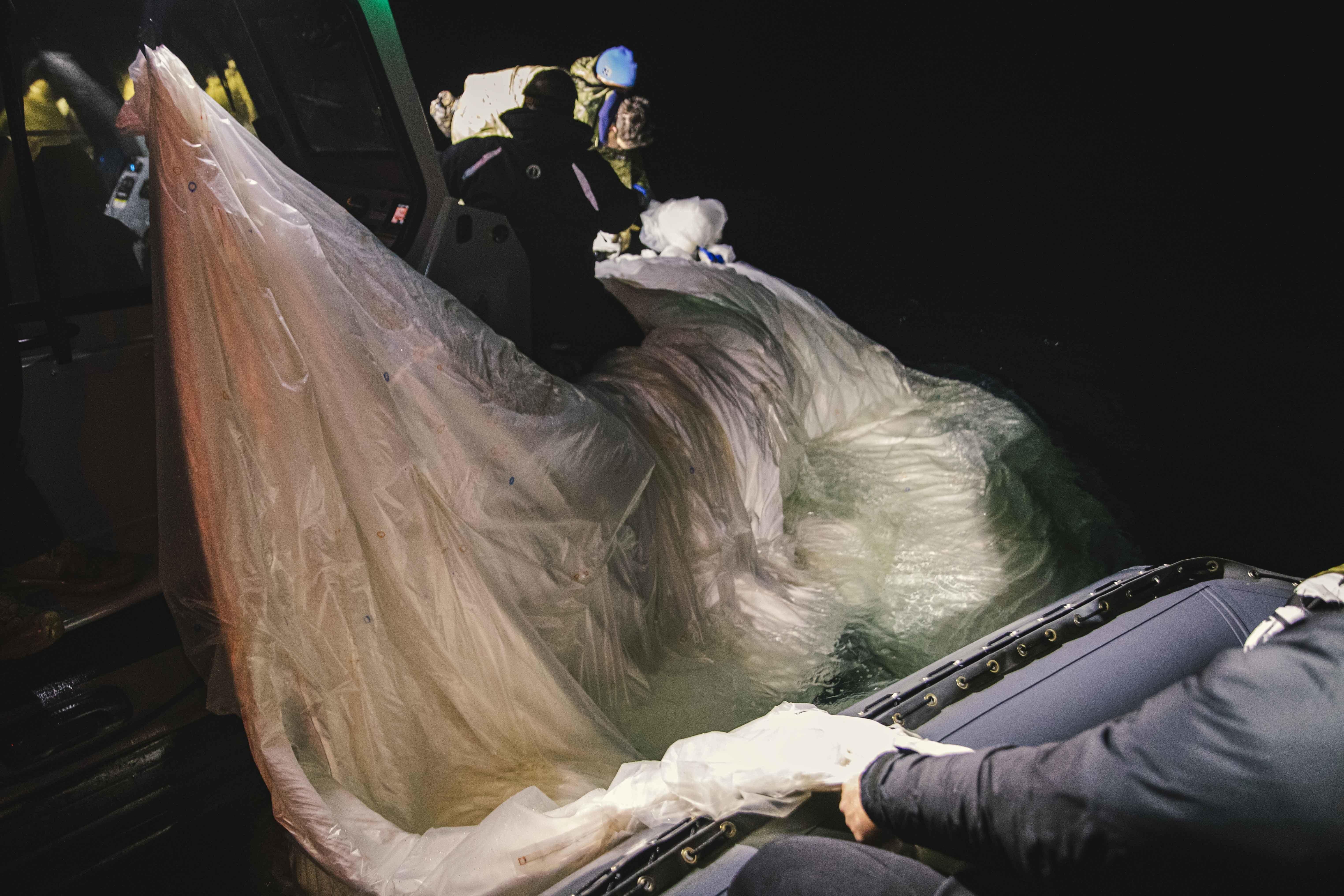 Another view of the balloon debris being retrieved from the ocean.
