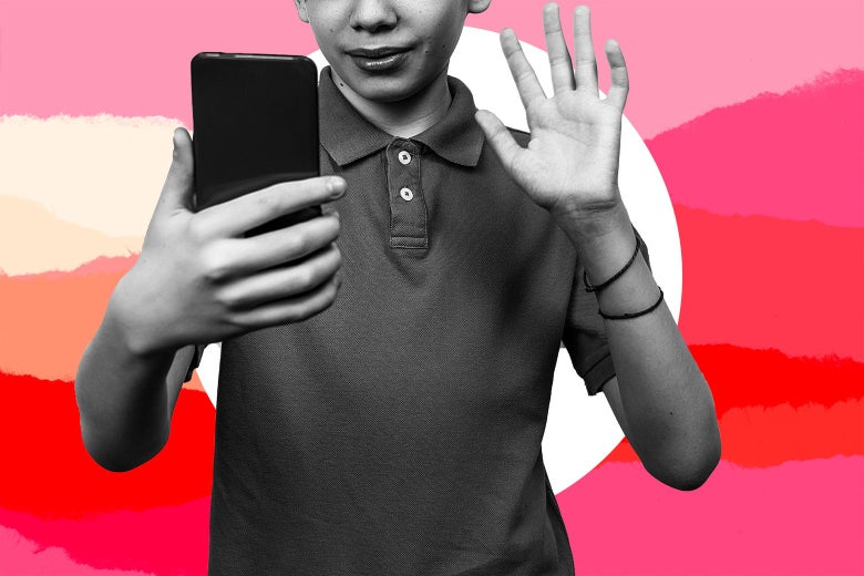 A 14-year-old boy waves at his cell phone. 