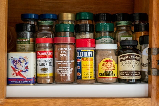 The three-tiered Expand-A-Shelf riser with spices on it.