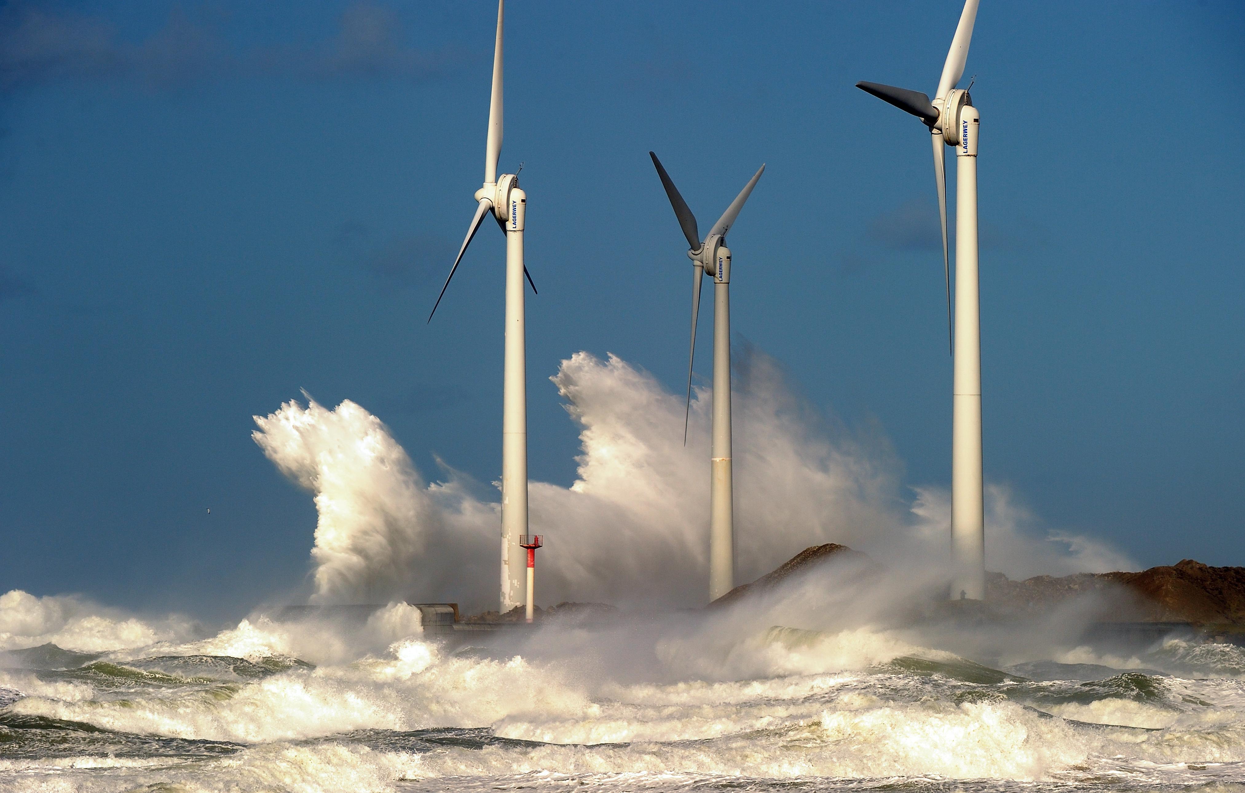 Waves break on a jetty holding wind turbines in the Channel port of Boulogne-sur-mer, France. 
