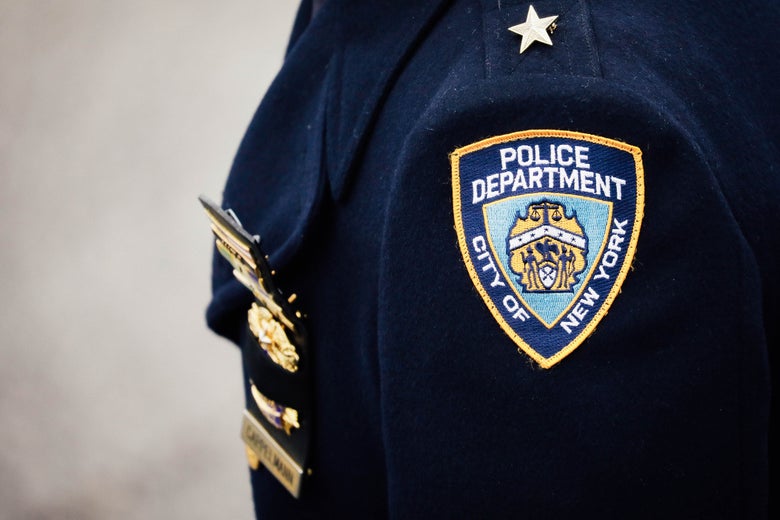 A shoulder of a NYPD officer shows a NYPD patch.