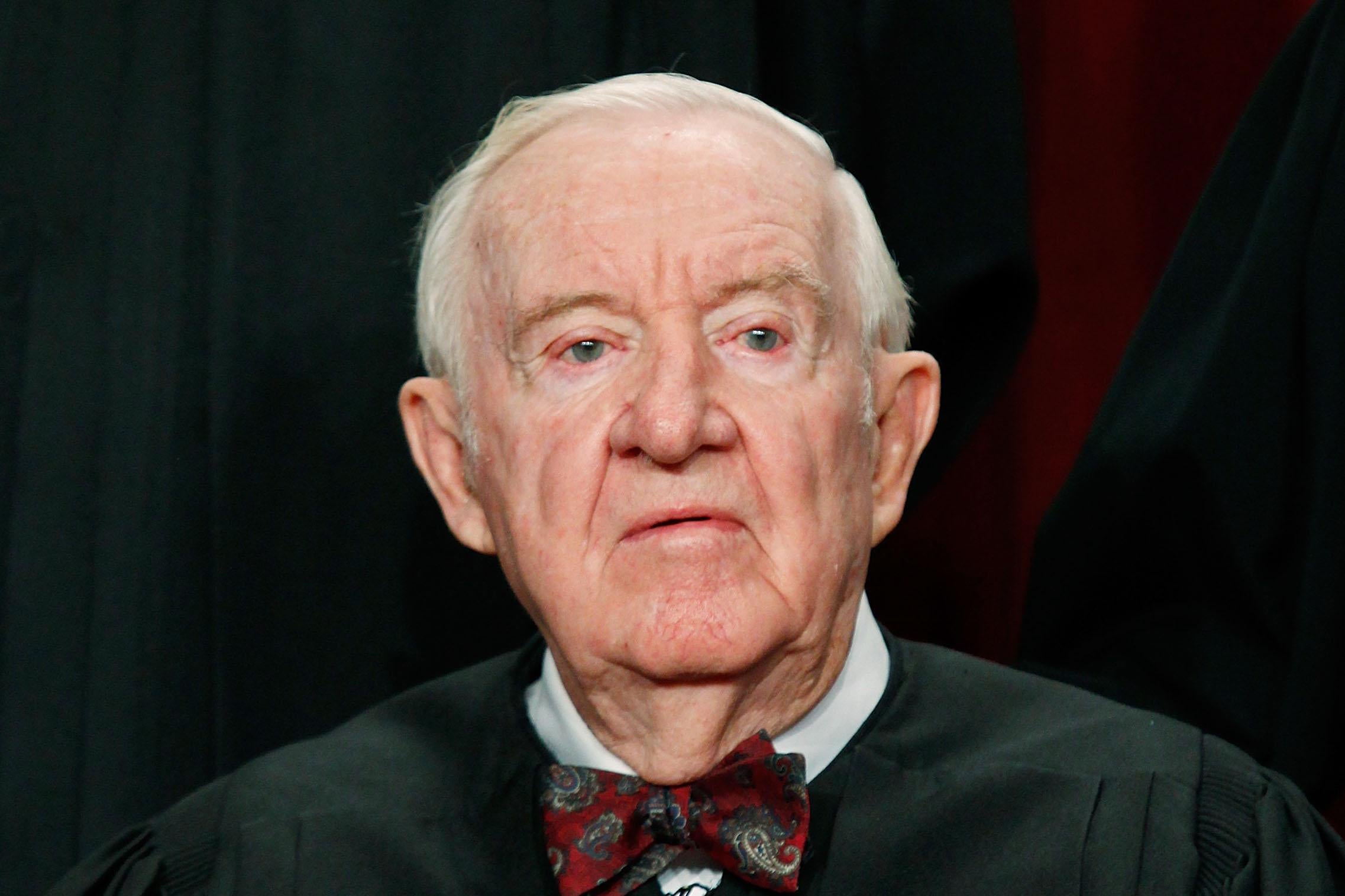 John Paul Stevens poses for a photo in his robes.