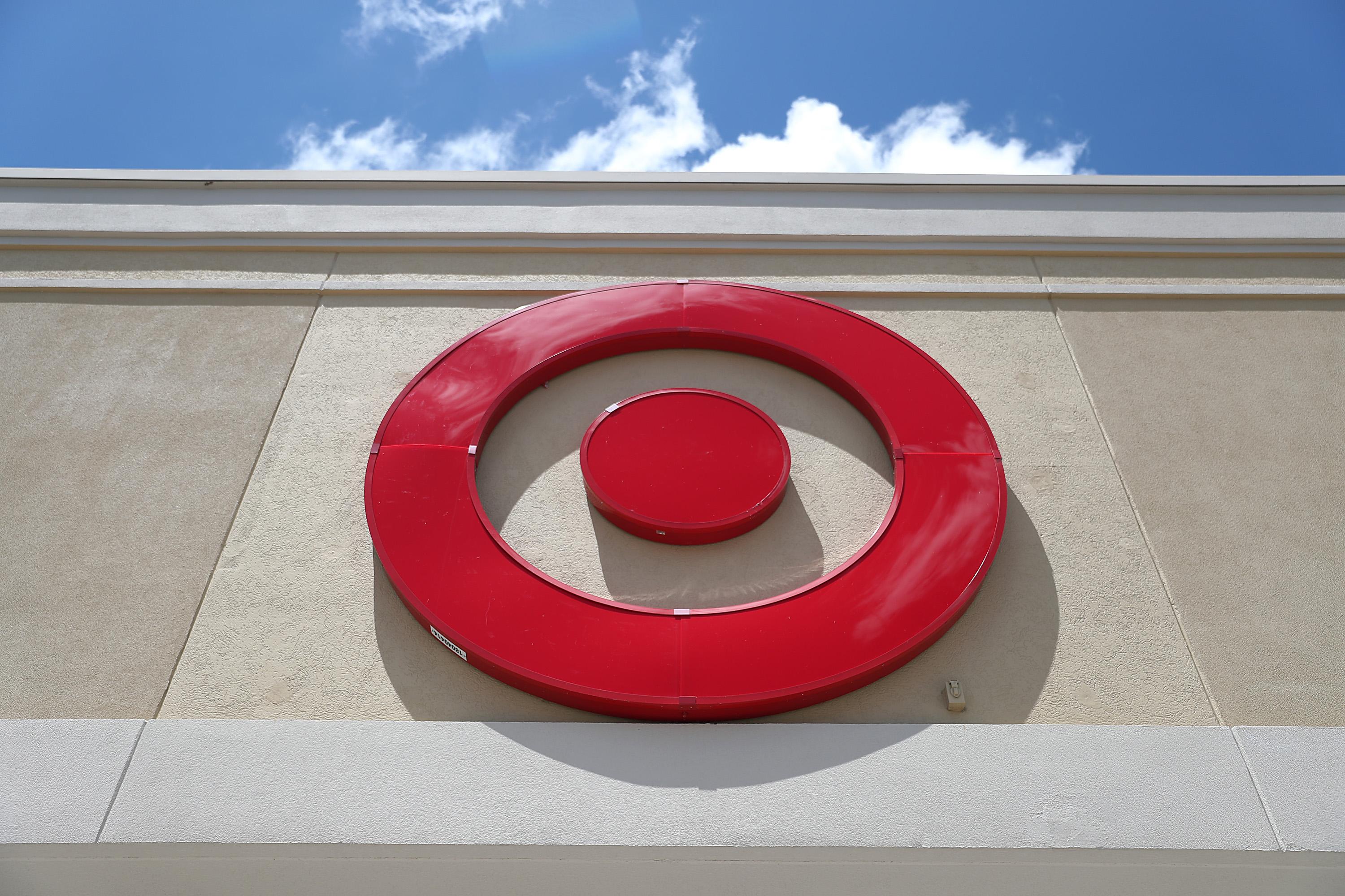 The bull’s-eye logo of a Target store's sign, with a blue sky behind it.