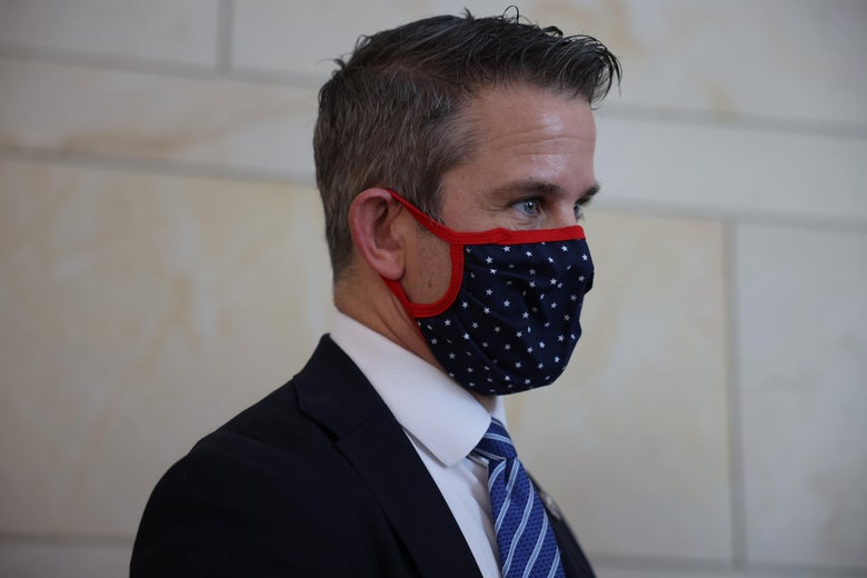 Side profile of Kinzinger wearing a blue mask with white stars and red trim